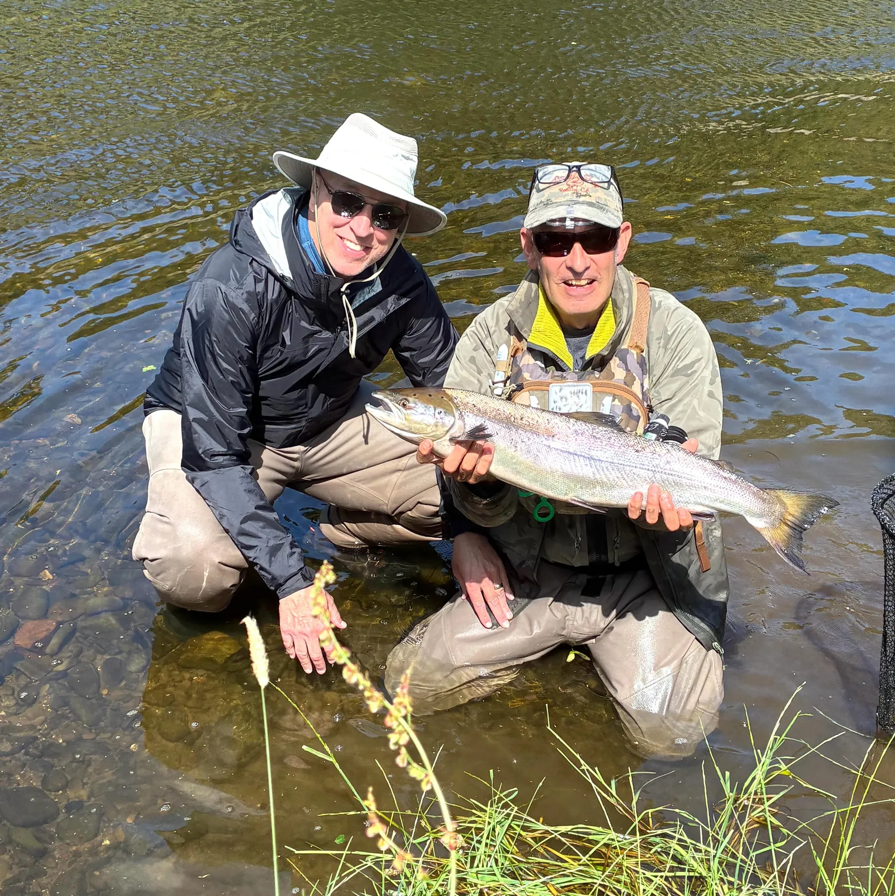 Two anglers enjoying a guided fishing day on a Scottish river